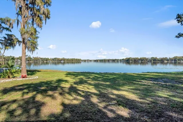a view of a lake with houses in the background