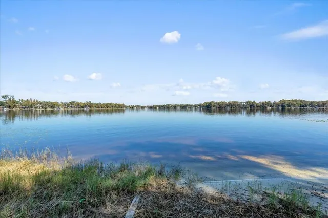 a view of a lake with houses in the back