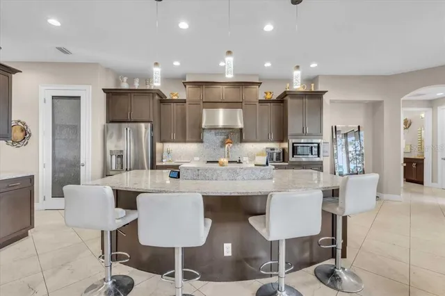 a large kitchen with a table and chairs