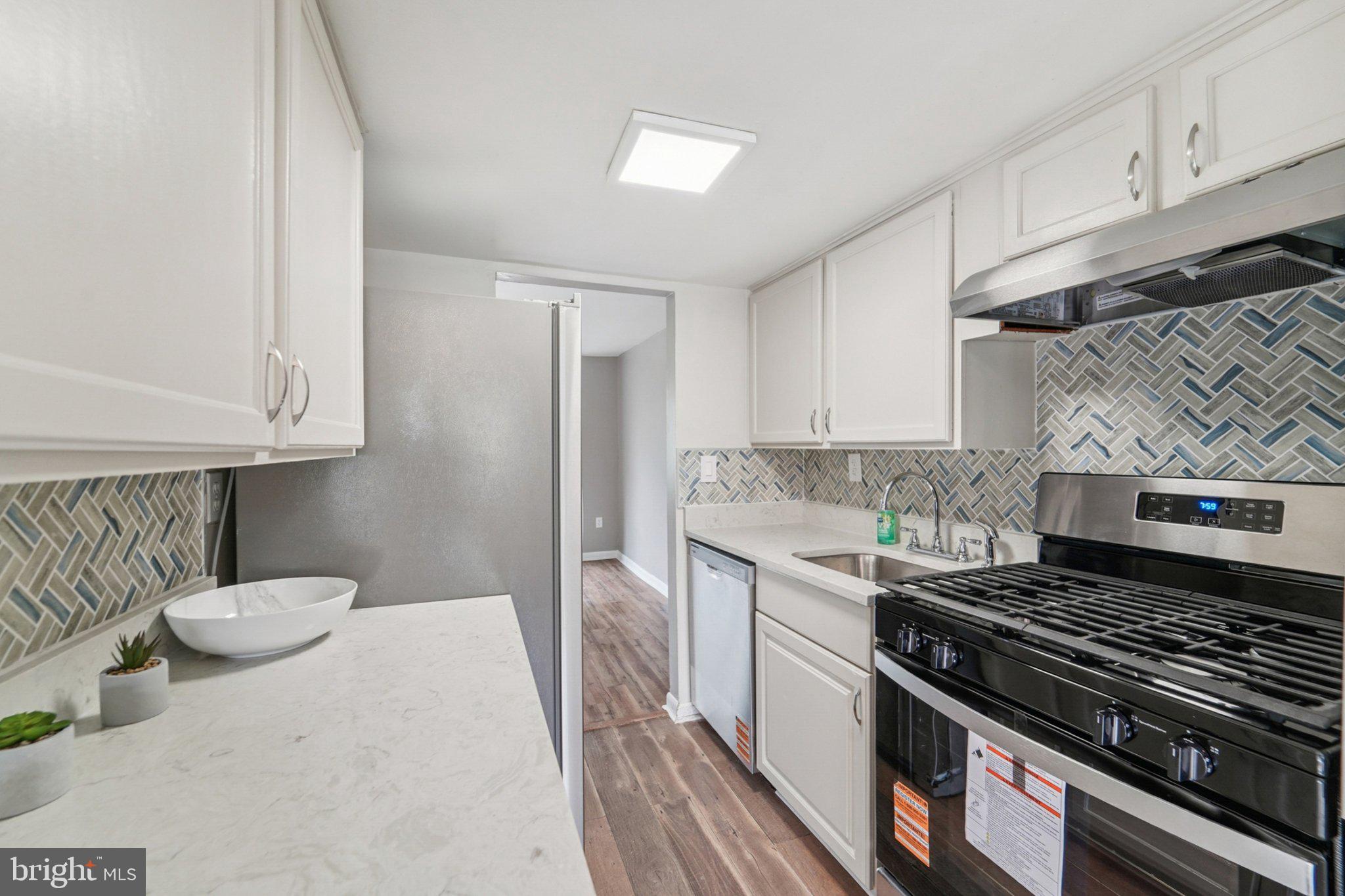 a kitchen with a stove and a sink
