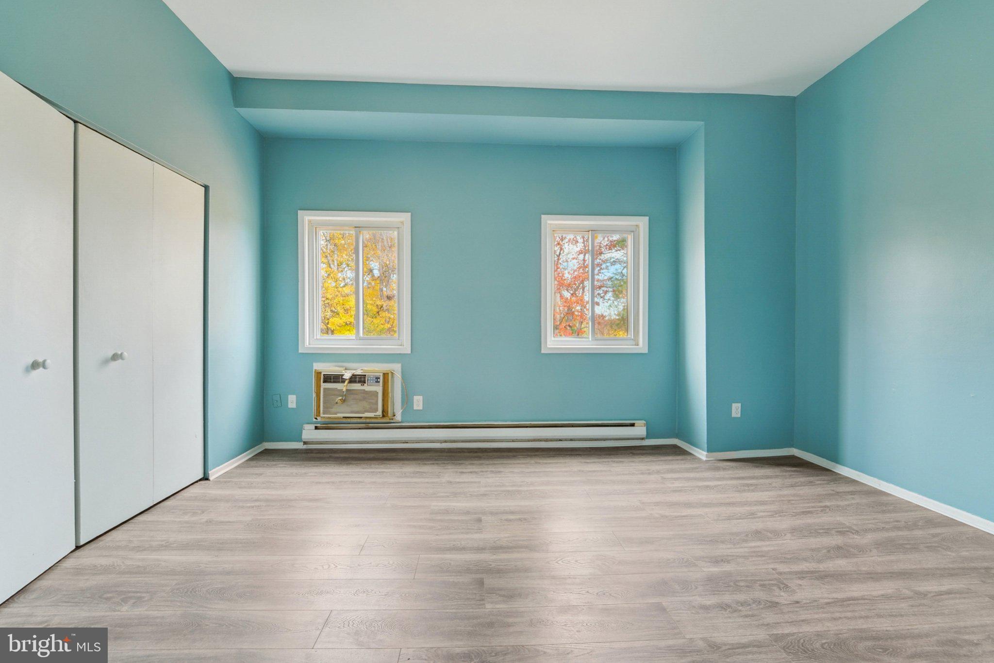 9432 Merryrest Road, Unit AB Columbia, MD 21045 - Photo 15 of 37 an empty room with wooden floor and windows