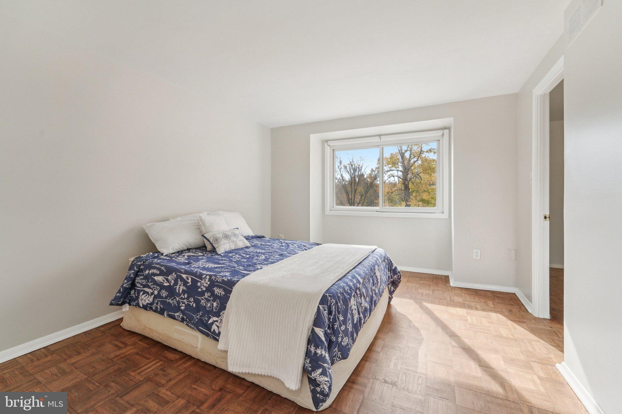 9432 Merryrest Road, Unit AB Columbia, MD 21045 - Photo 22 of 37 a bedroom with a large bed and a window