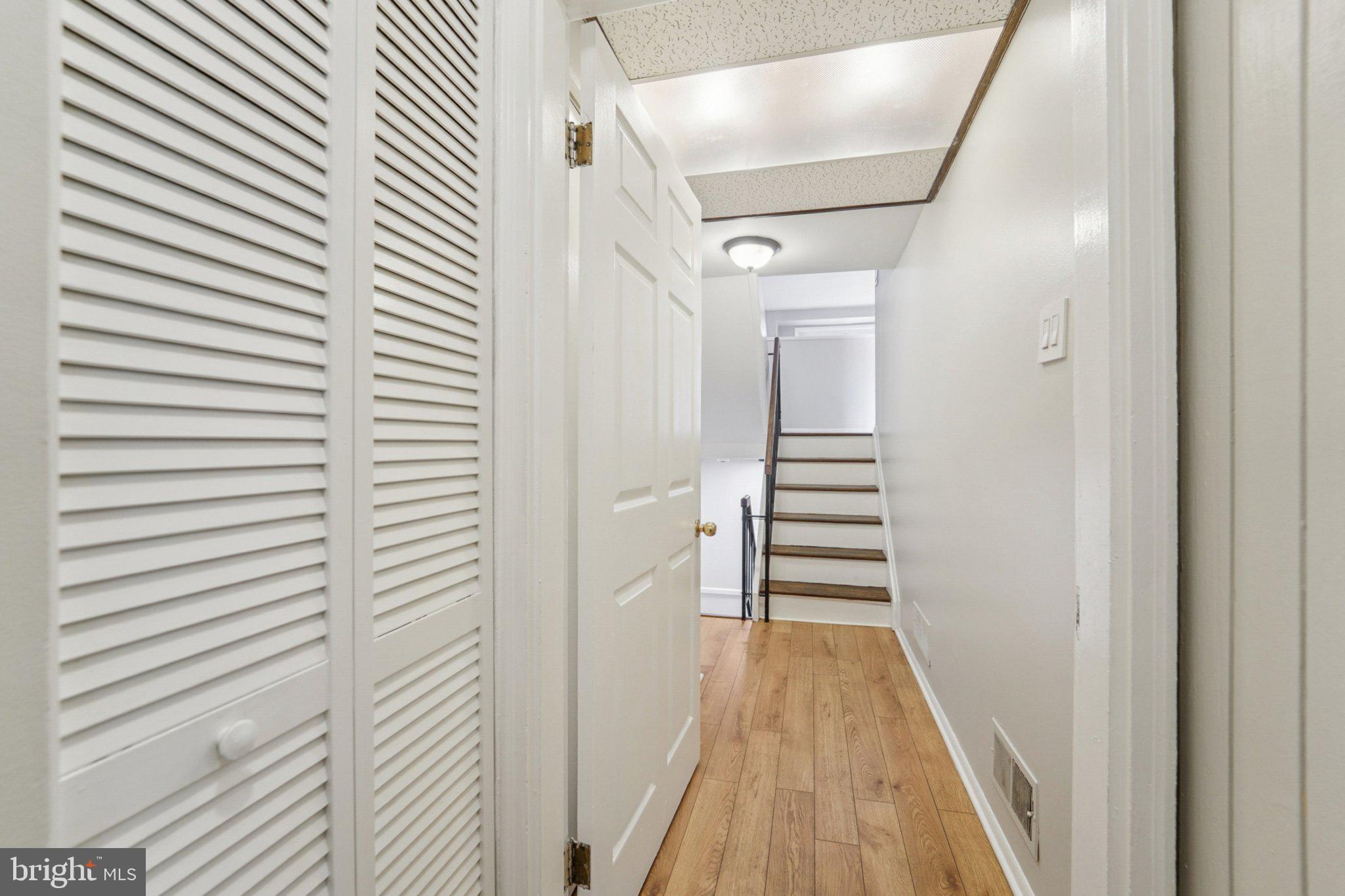 9432 Merryrest Road, Unit AB Columbia, MD 21045 - Photo 25 of 37 a view of a hallway with wooden floor and staircase