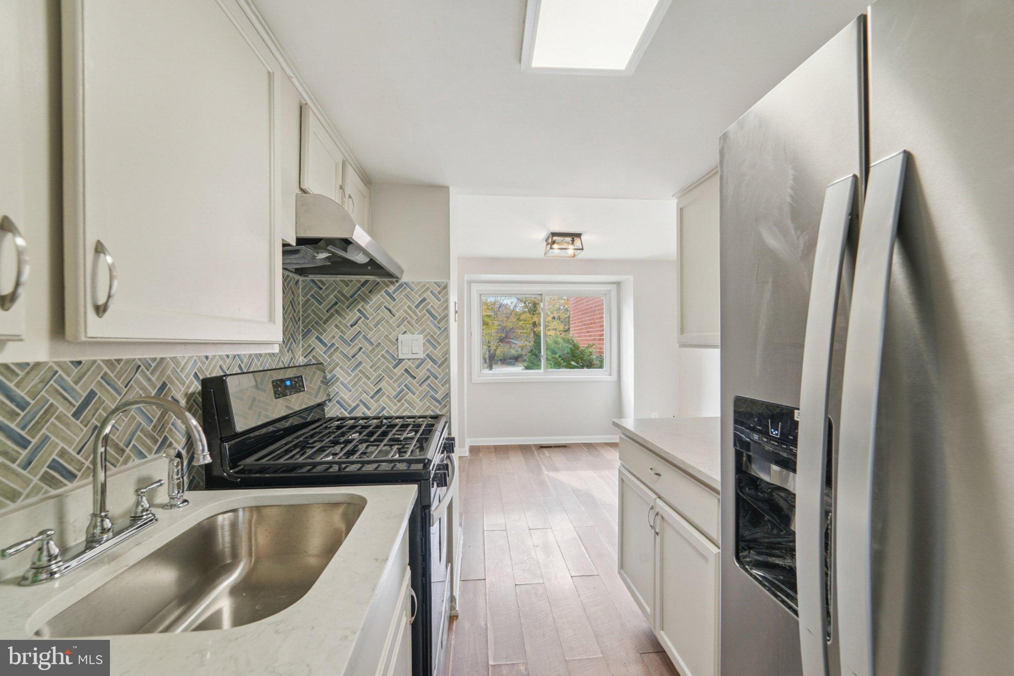 9432 Merryrest Road, Unit AB Columbia, MD 21045 - Photo 27 of 37 a kitchen with stainless steel appliances granite countertop a refrigerator and a sink