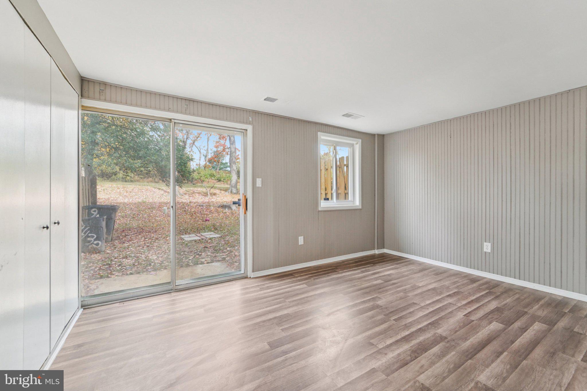9432 Merryrest Road, Unit AB Columbia, MD 21045 - Photo 31 of 37 a view of an empty room with wooden floor and a window