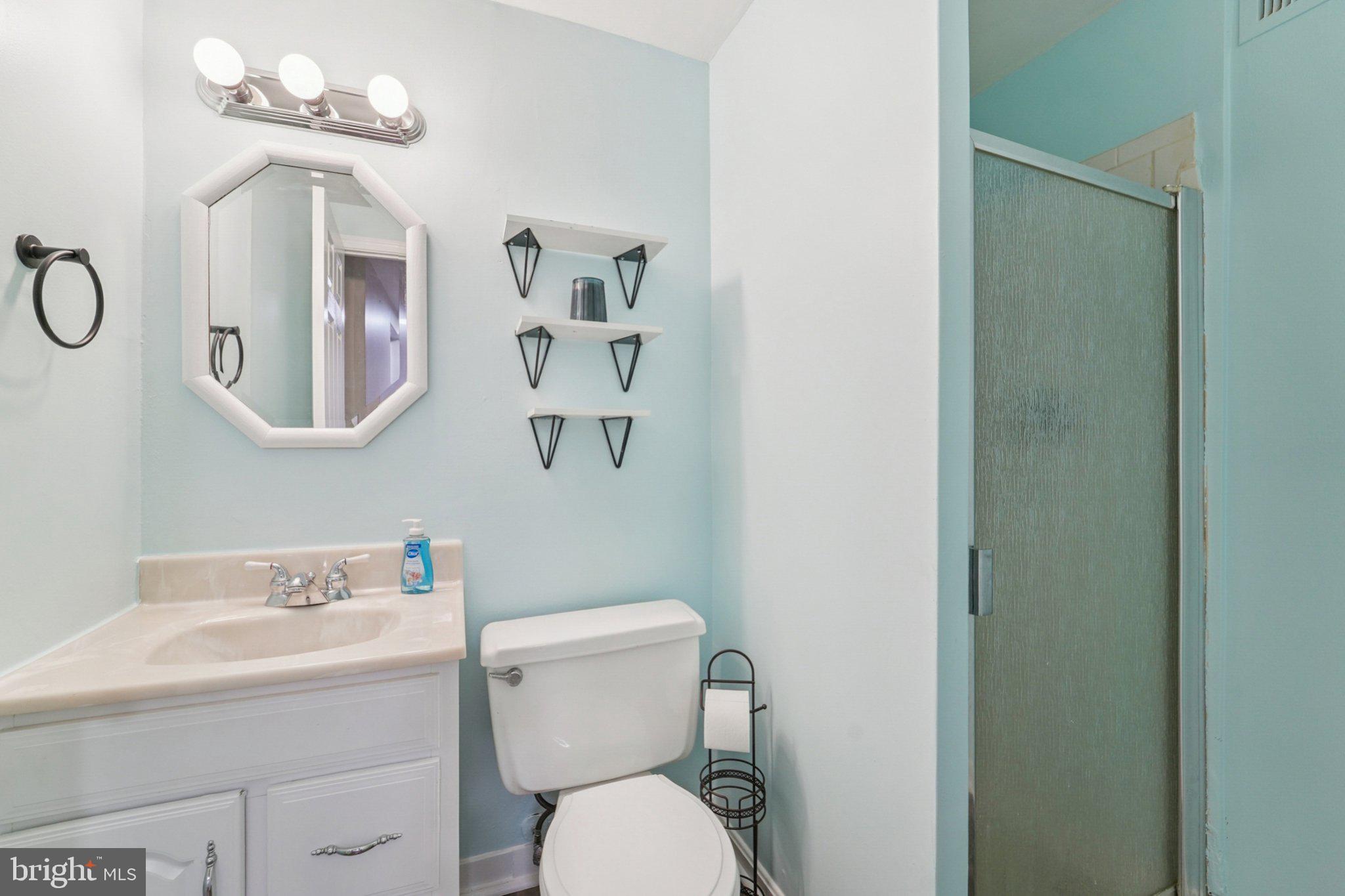 9432 Merryrest Road, Unit AB Columbia, MD 21045 - Photo 34 of 37 a white toilet sitting next to a bathroom sink