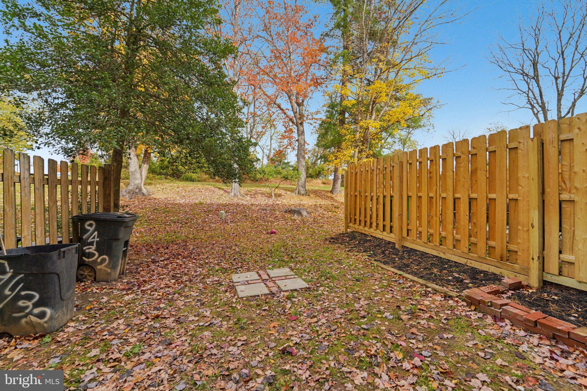9432 Merryrest Road, Unit AB Columbia, MD 21045 - Photo 36 of 37 a view of a backyard with wooden fence and a large tree