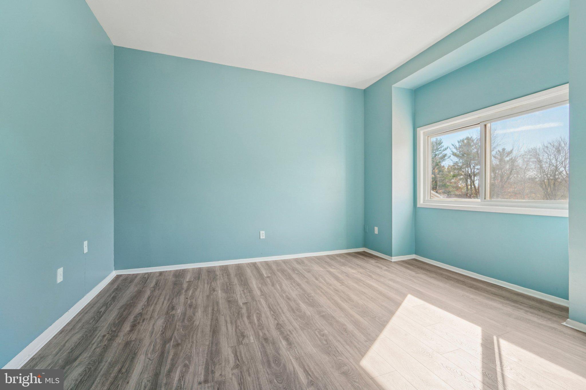 9432 Merryrest Road, Unit AB Columbia, MD 21045 - Photo 9 of 37 a view of a room with wooden floor and windows