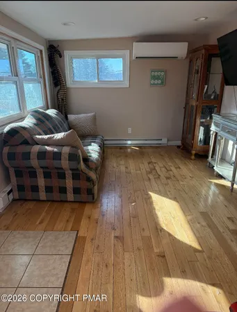 a view of a livingroom with an empty space and a ceiling fan