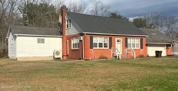 a view of a house with wooden deck