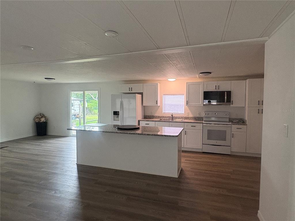 3923 Ward Road Lakeland, FL 33810 - Photo 11 of 25 a kitchen with a sink cabinets and wooden floor