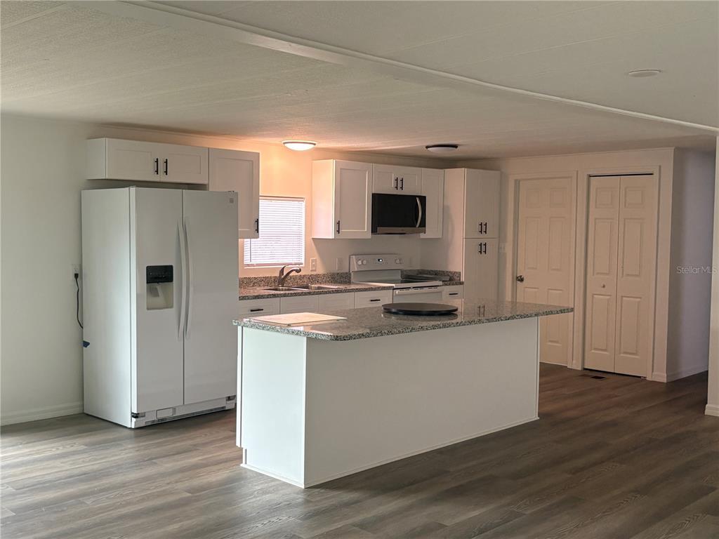3923 Ward Road Lakeland, FL 33810 - Photo 17 of 25 a kitchen with stainless steel appliances a refrigerator and a stove top oven