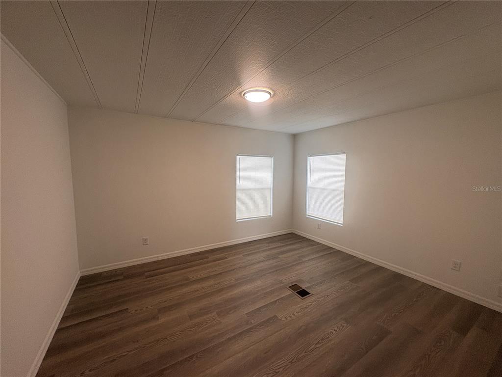 3923 Ward Road Lakeland, FL 33810 - Photo 18 of 25 wooden floor in an empty room with a window