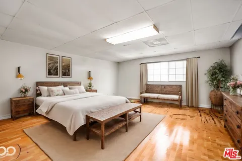 a spacious bedroom with a large bed and a couch