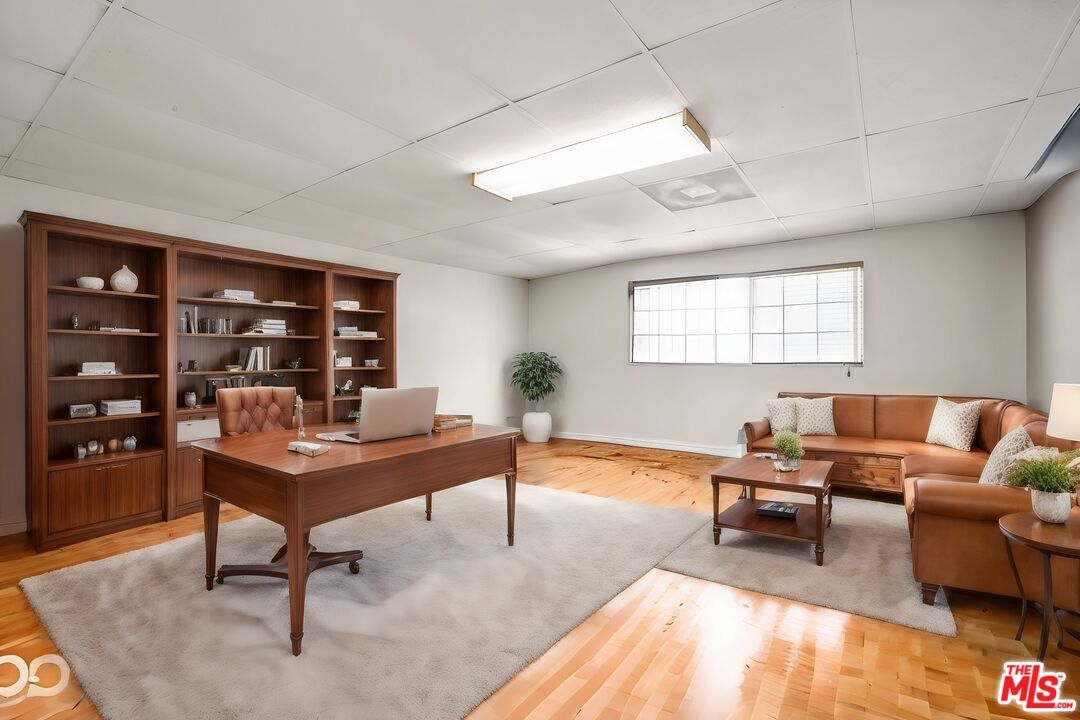 2477 Coolidge Avenue Los Angeles, CA 90064 - Photo 16 of 30 a living room with furniture a lamp and a bookshelf