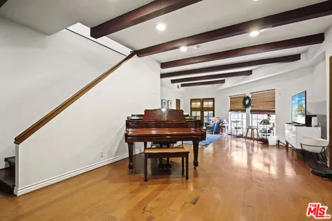 a living room with furniture and a piano