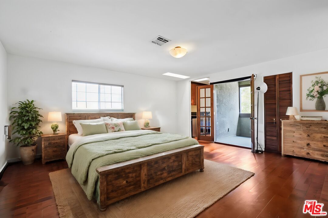 2477 Coolidge Avenue Los Angeles, CA 90064 - Photo 5 of 30 a bedroom with a large bed and a chandelier