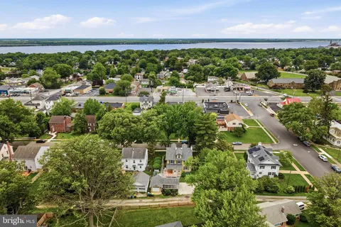 an aerial view of residential houses with outdoor space and street view