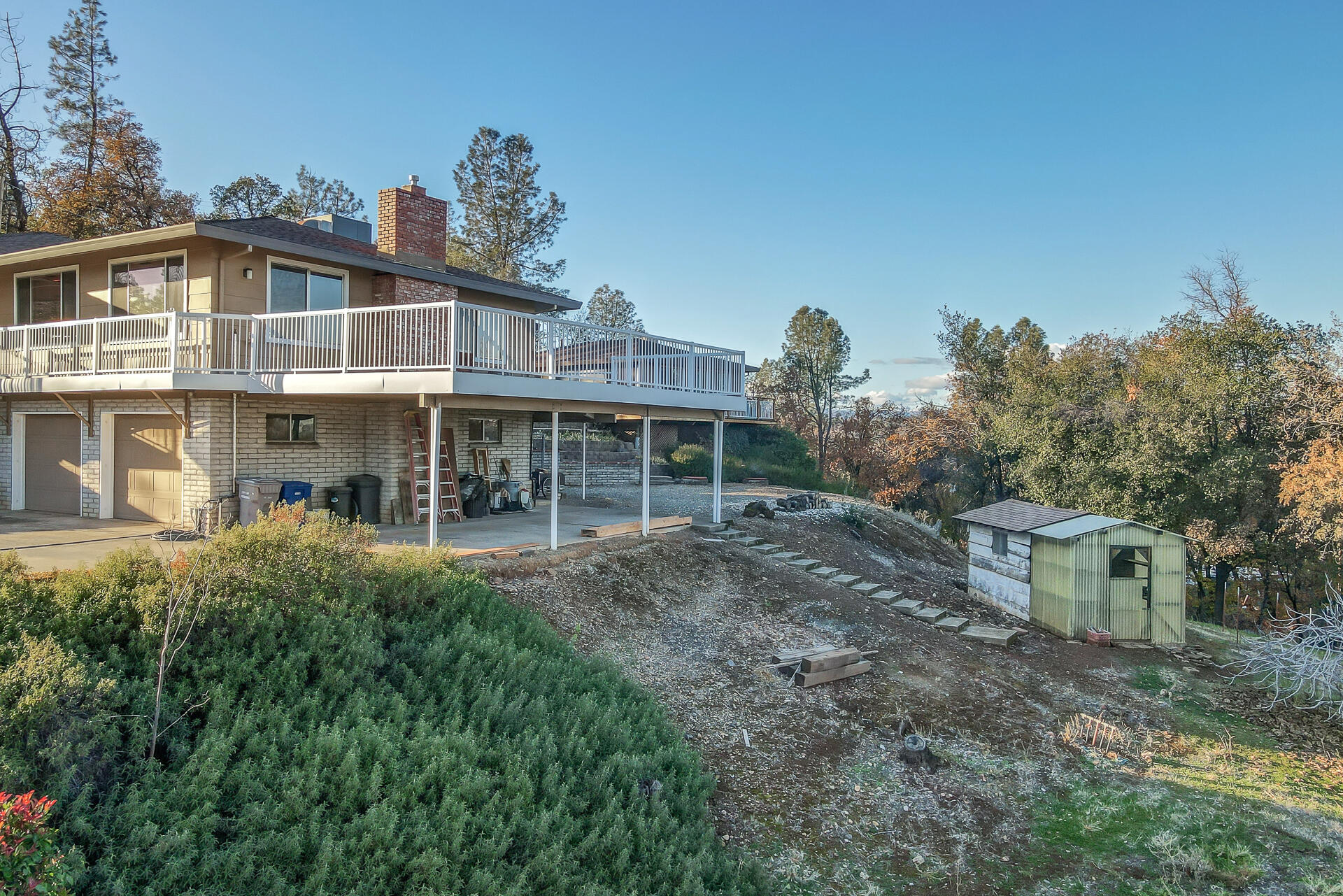 8738 Prospectors Road Redding, CA 96001 - Photo 57 of 63 a front view of a house with a yard and trees