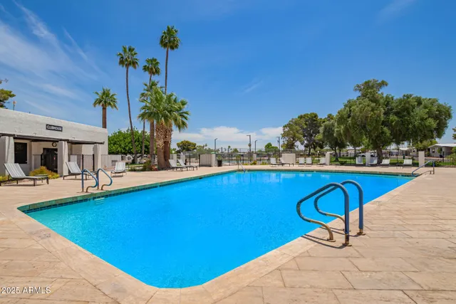 a view of swimming pool with outdoor seating and plants