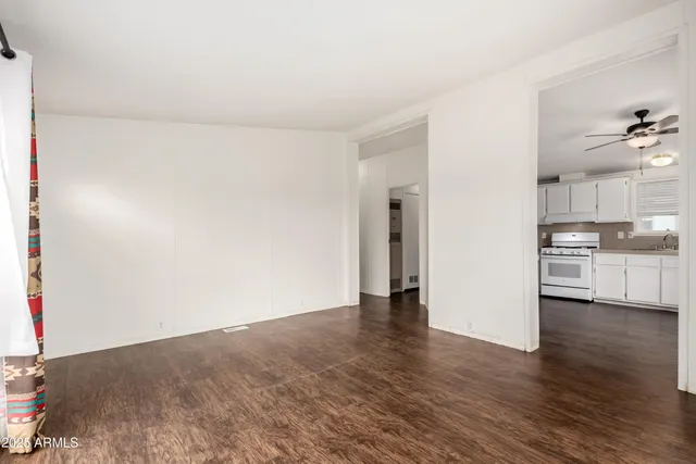 a view of a kitchen with a sink and a refrigerator