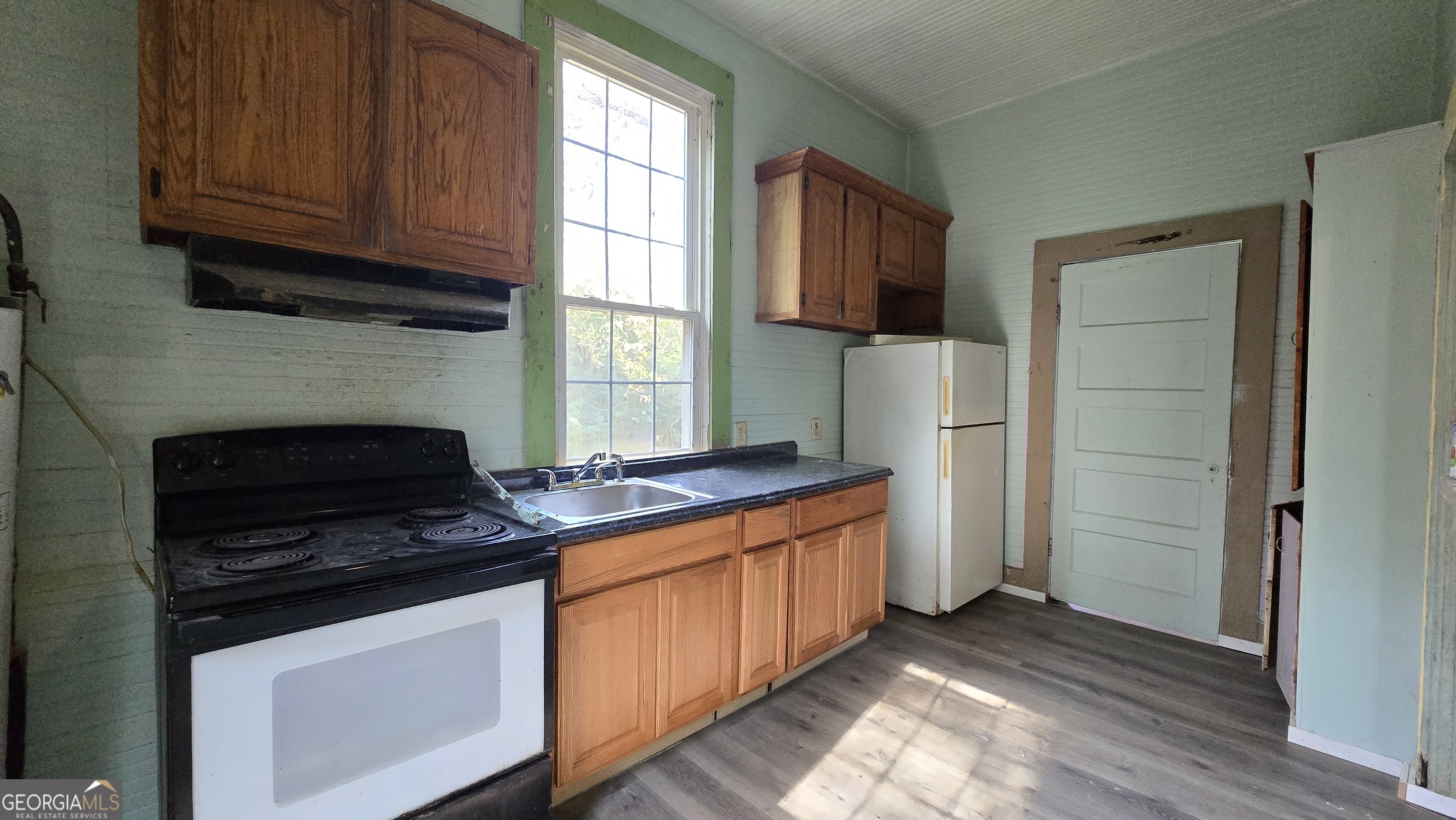 509 Anderson Avenue Fort Valley, GA 31030 - Photo 11 of 22 a kitchen with stainless steel appliances granite countertop a stove a refrigerator and a stove top oven