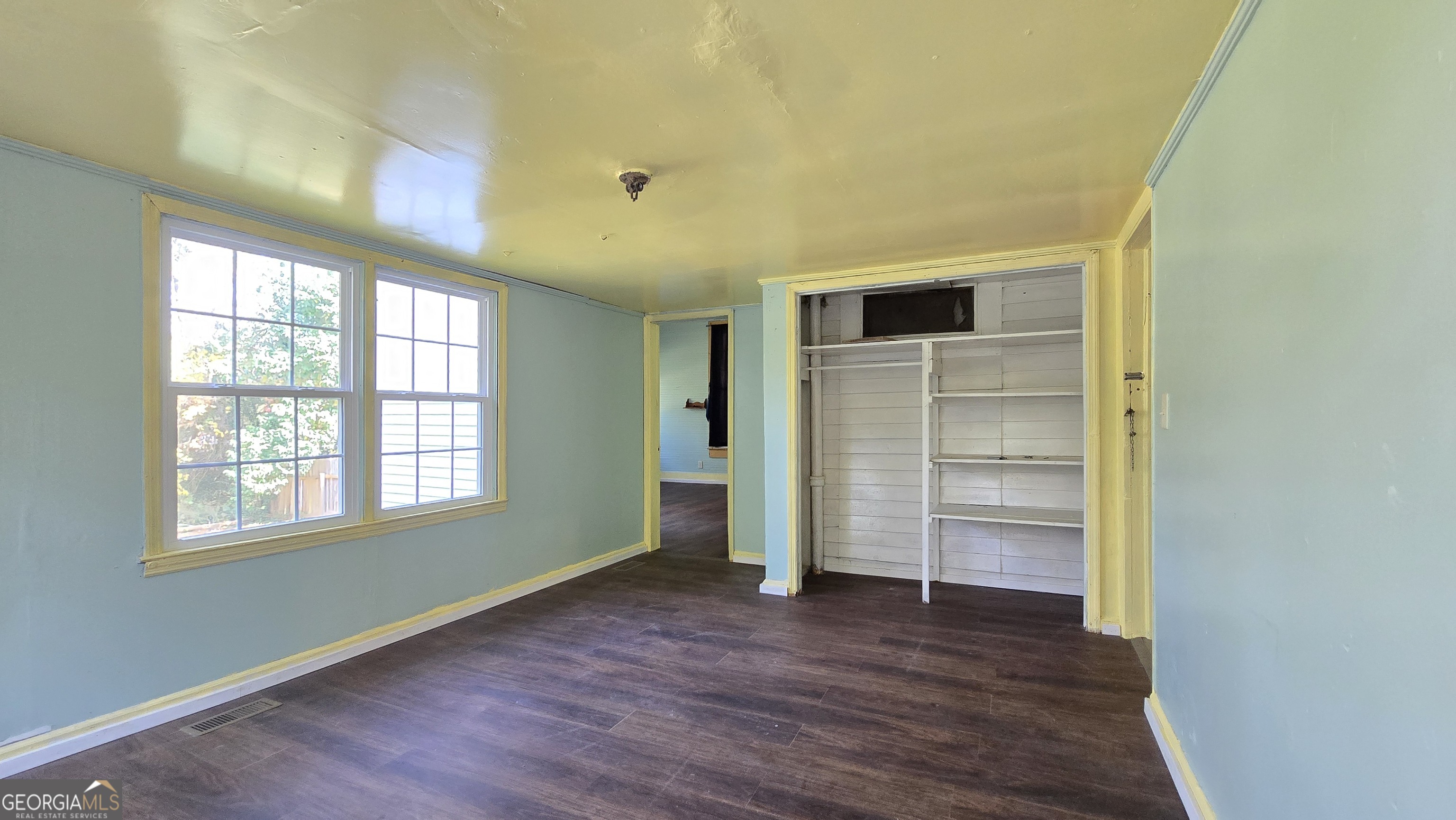 509 Anderson Avenue Fort Valley, GA 31030 - Photo 15 of 22 wooden floor in an empty room with a window