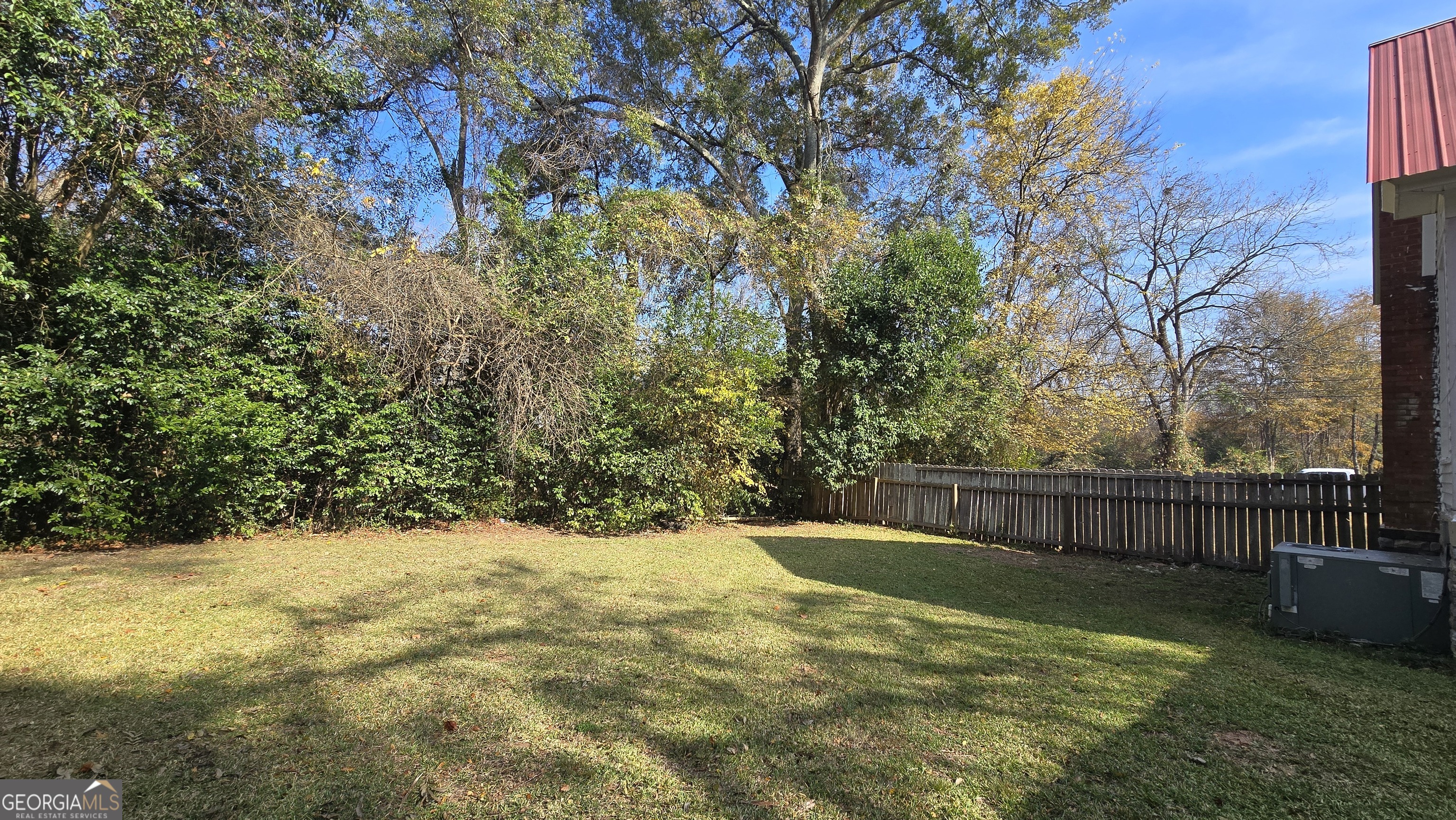 509 Anderson Avenue Fort Valley, GA 31030 - Photo 19 of 22 a view of a yard with large tree and wooden fence