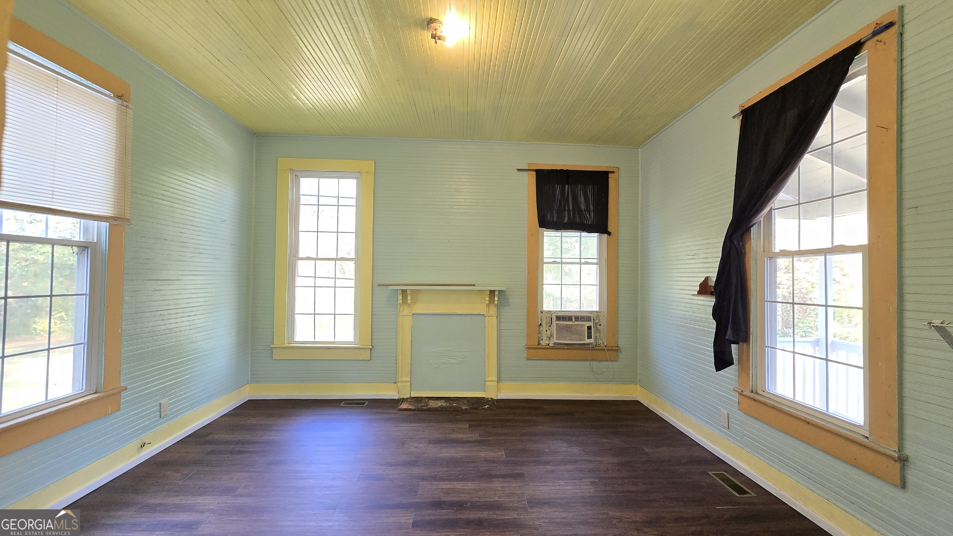 509 Anderson Avenue Fort Valley, GA 31030 - Photo 6 of 22 a view of an empty room with wooden floor and a window