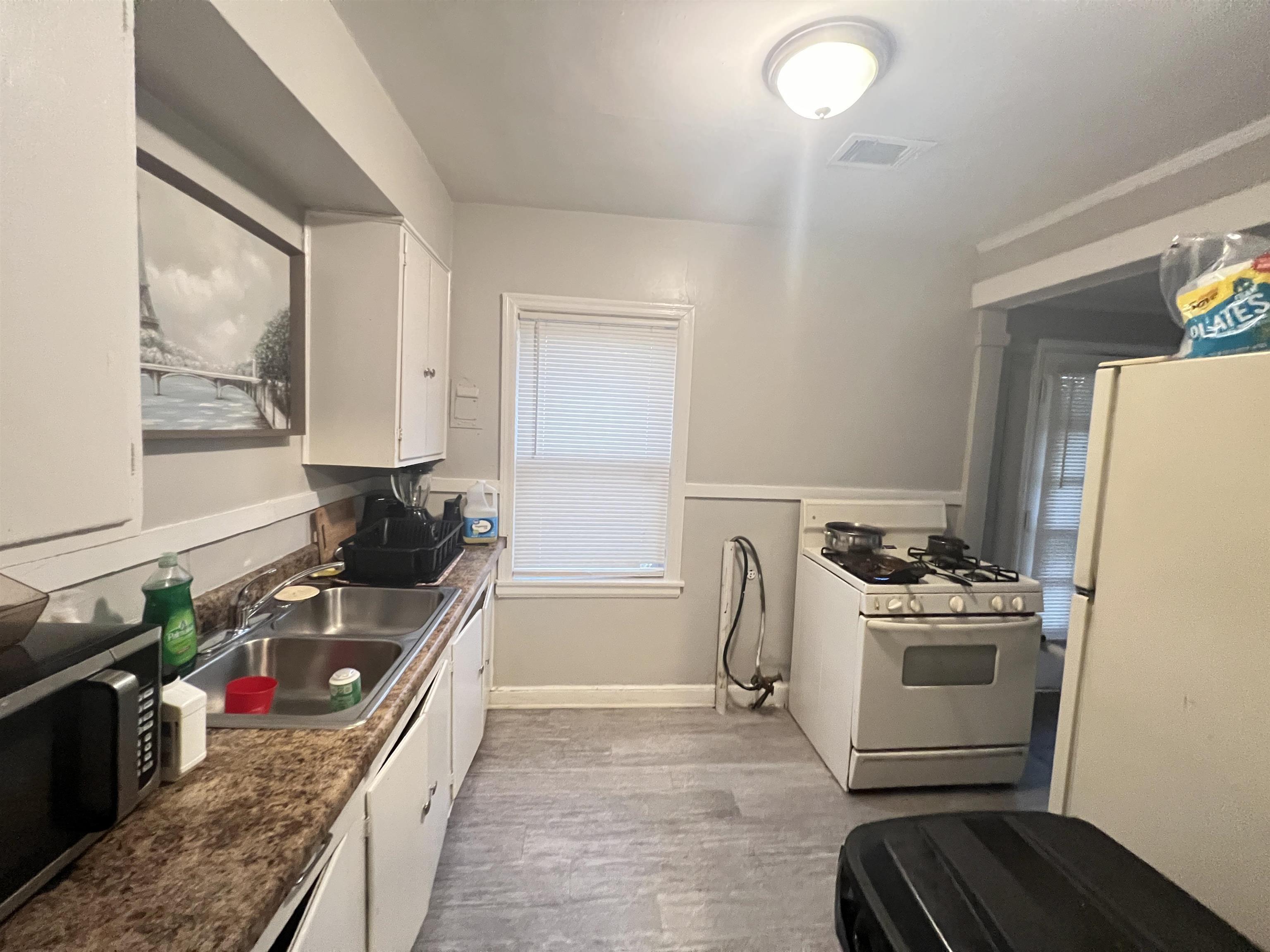 1007 Railton Road Memphis, TN 38111 - Photo 5 of 12 a kitchen with a stove and a refrigerator
