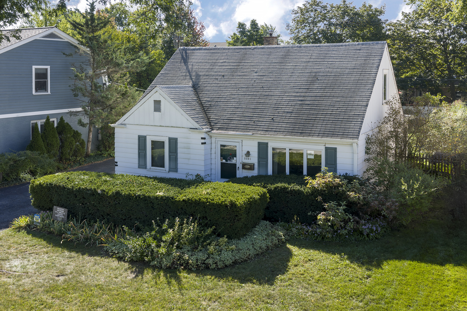 a front view of a house with a garden