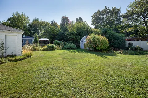 a backyard of a house with a garden and plants
