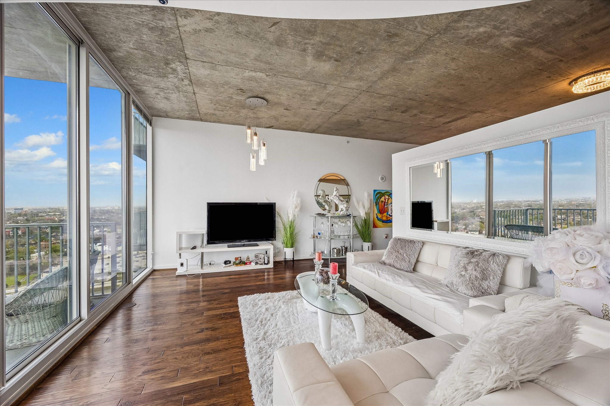 5925 Almeda Road, Unit 11907 Houston, TX 77004 - Photo 8 of 35 a living room with furniture flat screen tv and a floor to ceiling window