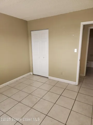 a view of an empty room and wooden floor