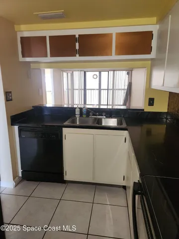 a kitchen with a sink a stove and a microwave