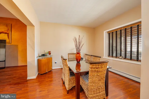 a dining room with furniture and wooden floor