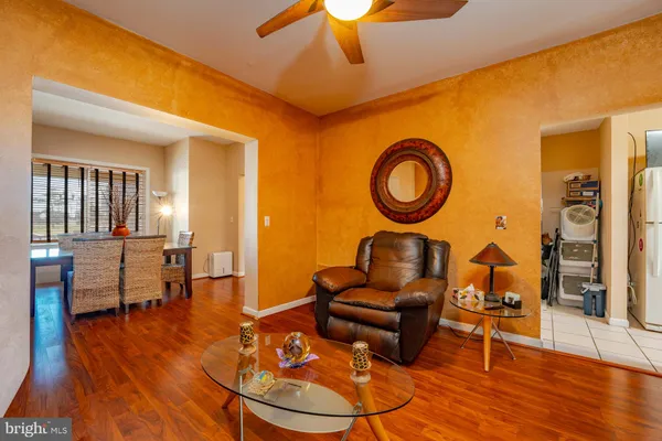 a living room with furniture a rug and a chandelier