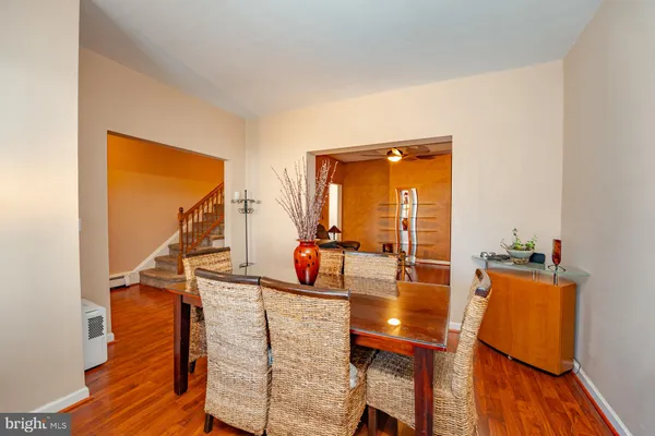 a dining room with furniture and wooden floor