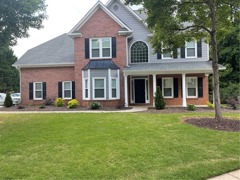 3265 Maple Terrace Drive Suwanee, GA 30024 - Photo 1 of 1 a front view of a house with swimming pool and porch