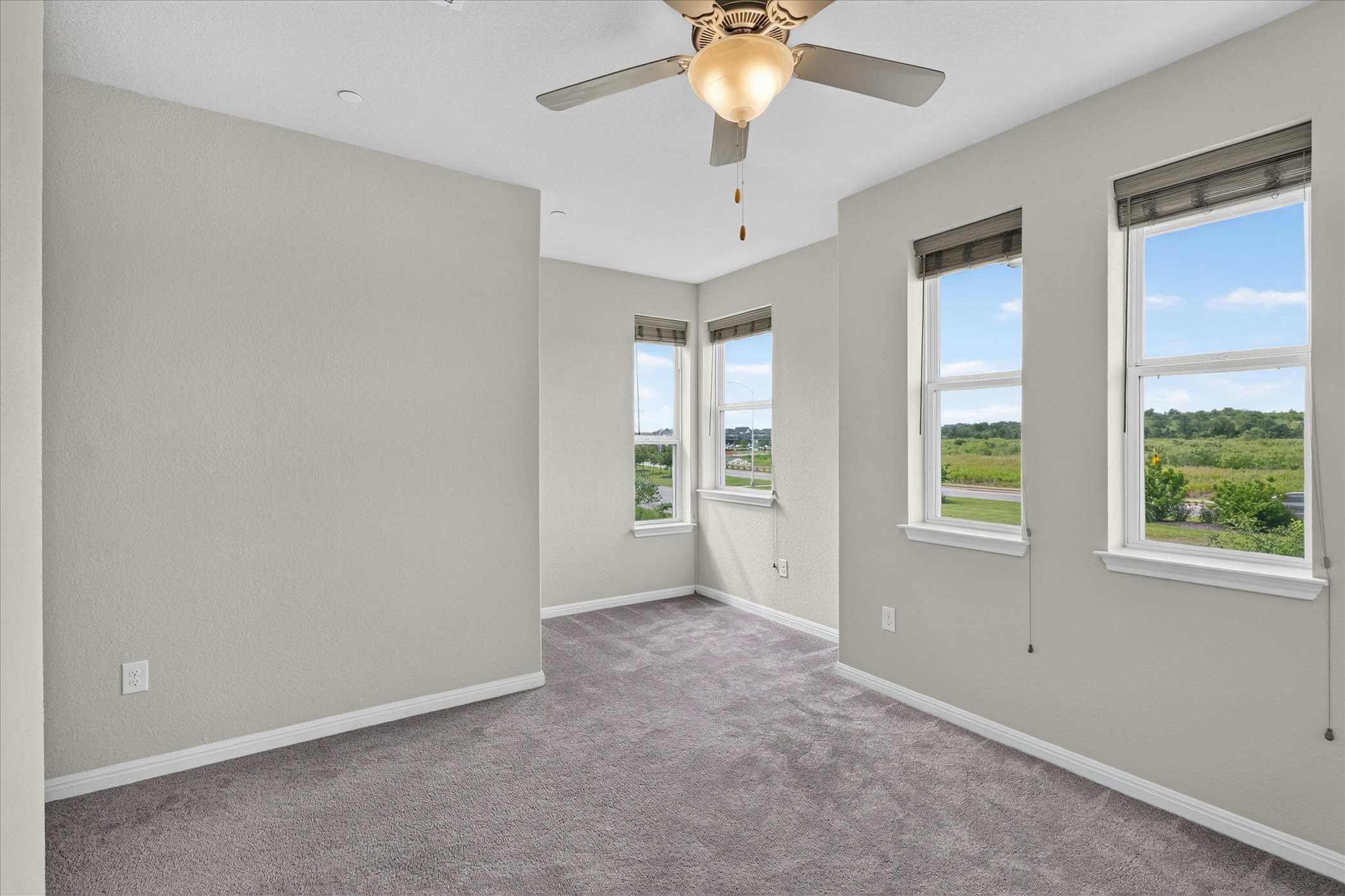 9015 Cattle Baron Path, Unit 1102 Austin, TX 78747 - Photo 16 of 25 A well-lit bedroom features multiple windows offering a serene view of the outdoors.