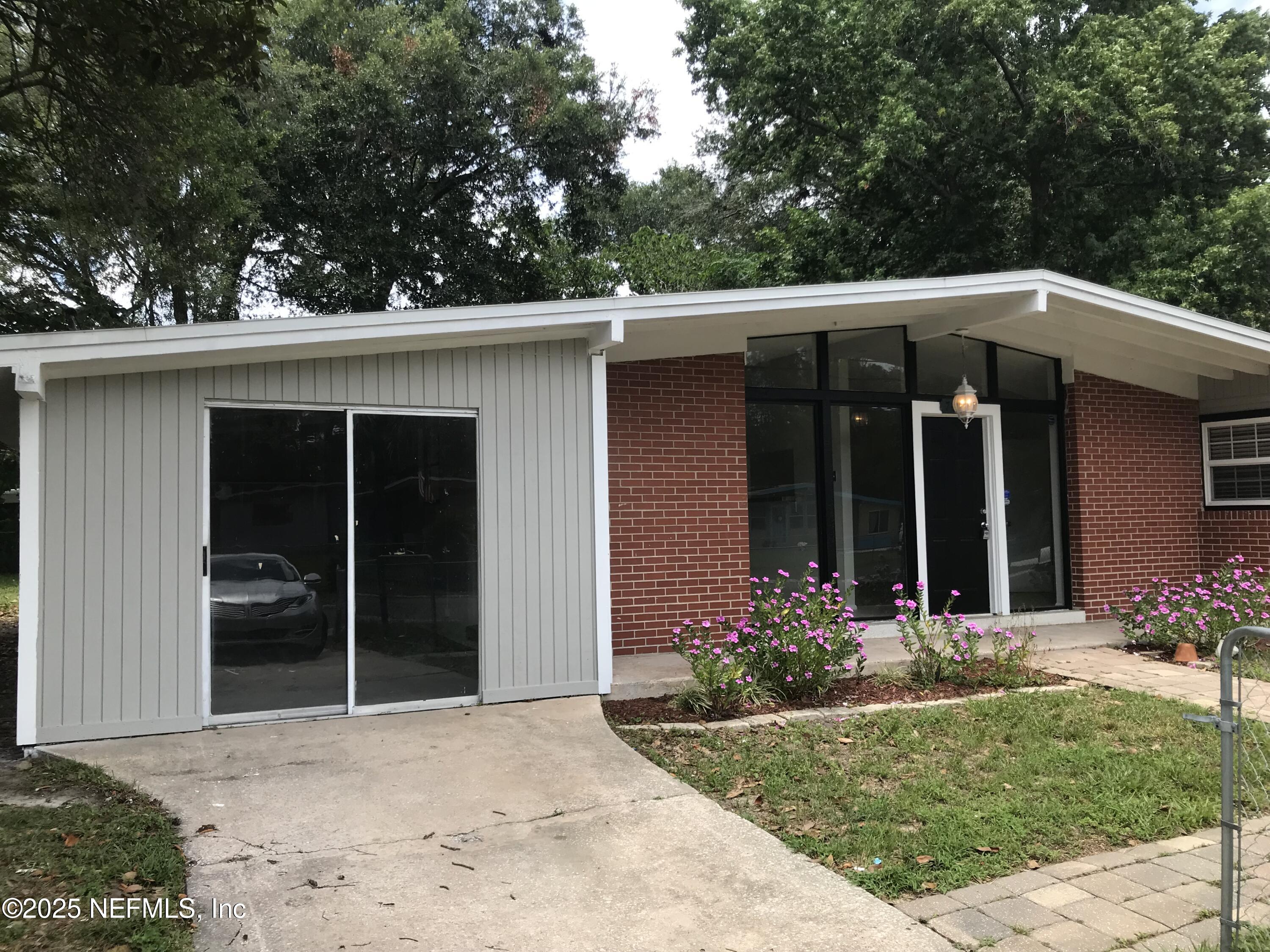 7419 Sandhurst Road South Jacksonville, FL 32277 - Photo 1 of 16 front view of a house with a yard