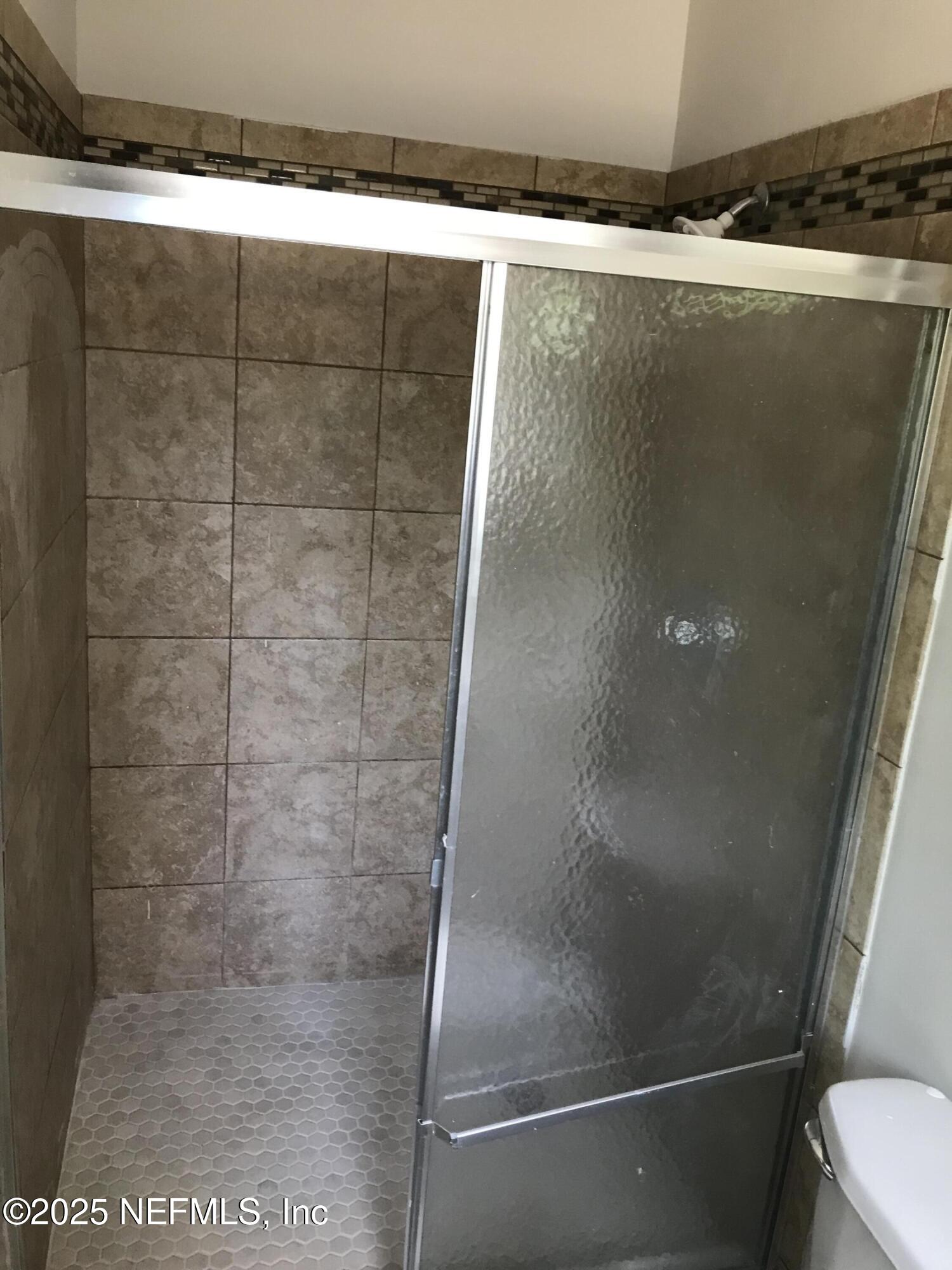 7419 Sandhurst Road South Jacksonville, FL 32277 - Photo 12 of 16 a bathroom with a shower