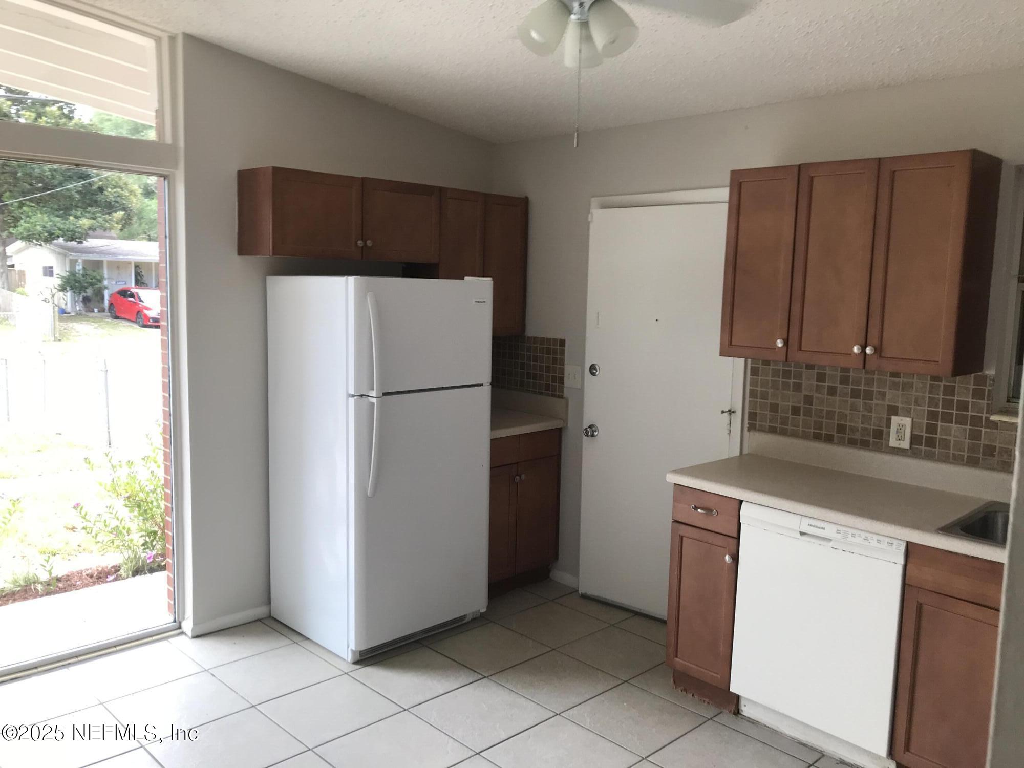7419 Sandhurst Road South Jacksonville, FL 32277 - Photo 4 of 16 a kitchen with a refrigerator sink and cabinets