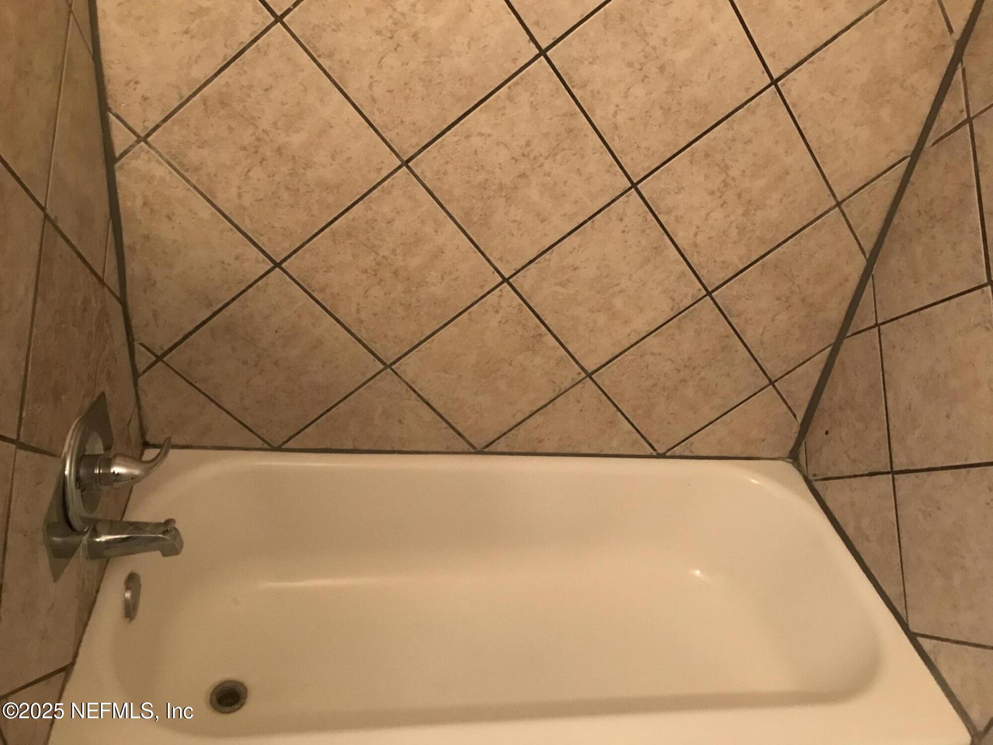 7419 Sandhurst Road South Jacksonville, FL 32277 - Photo 8 of 16 a bathroom with a bath tub