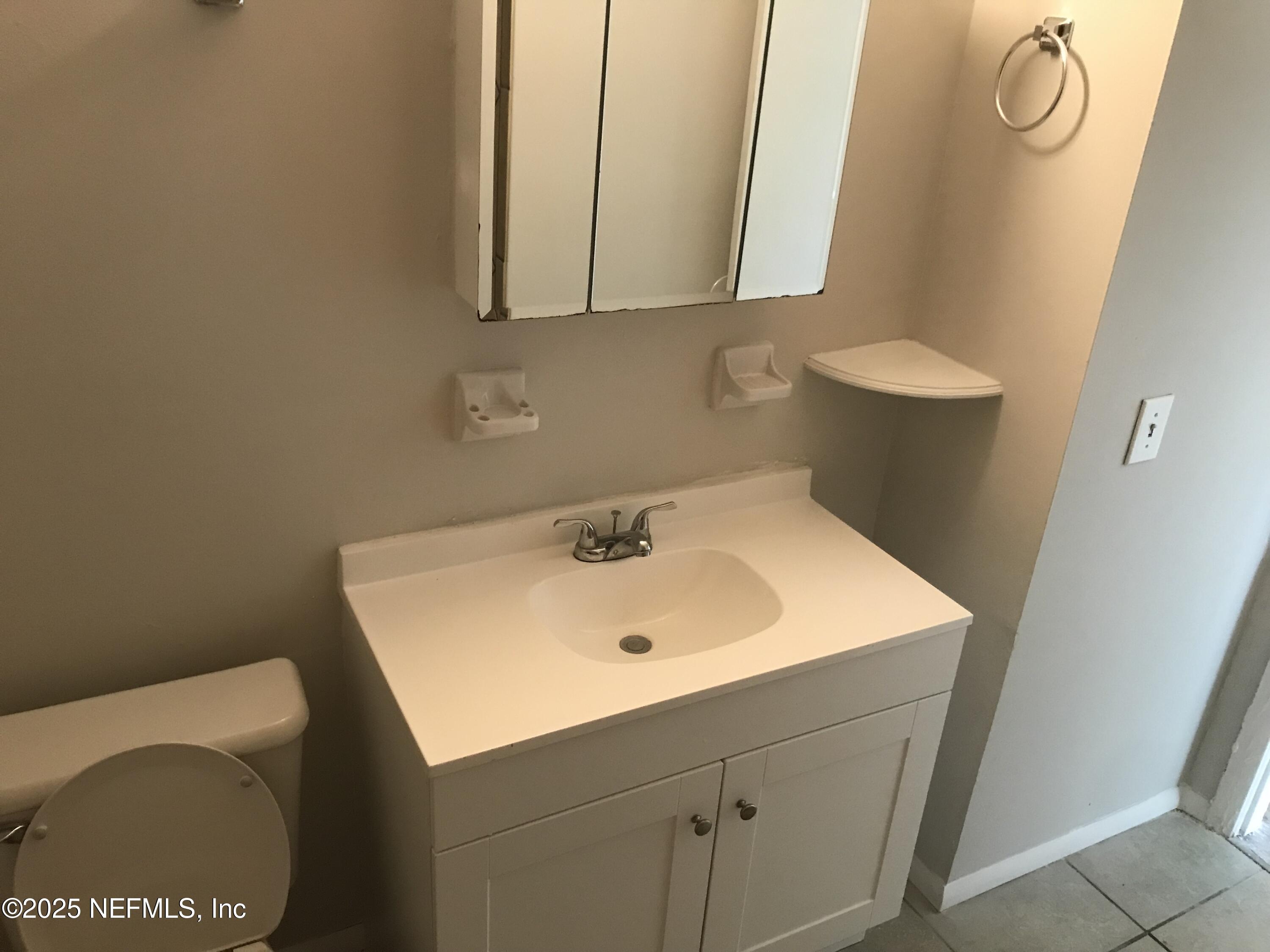 7419 Sandhurst Road South Jacksonville, FL 32277 - Photo 9 of 16 a bathroom with a sink and a toilet