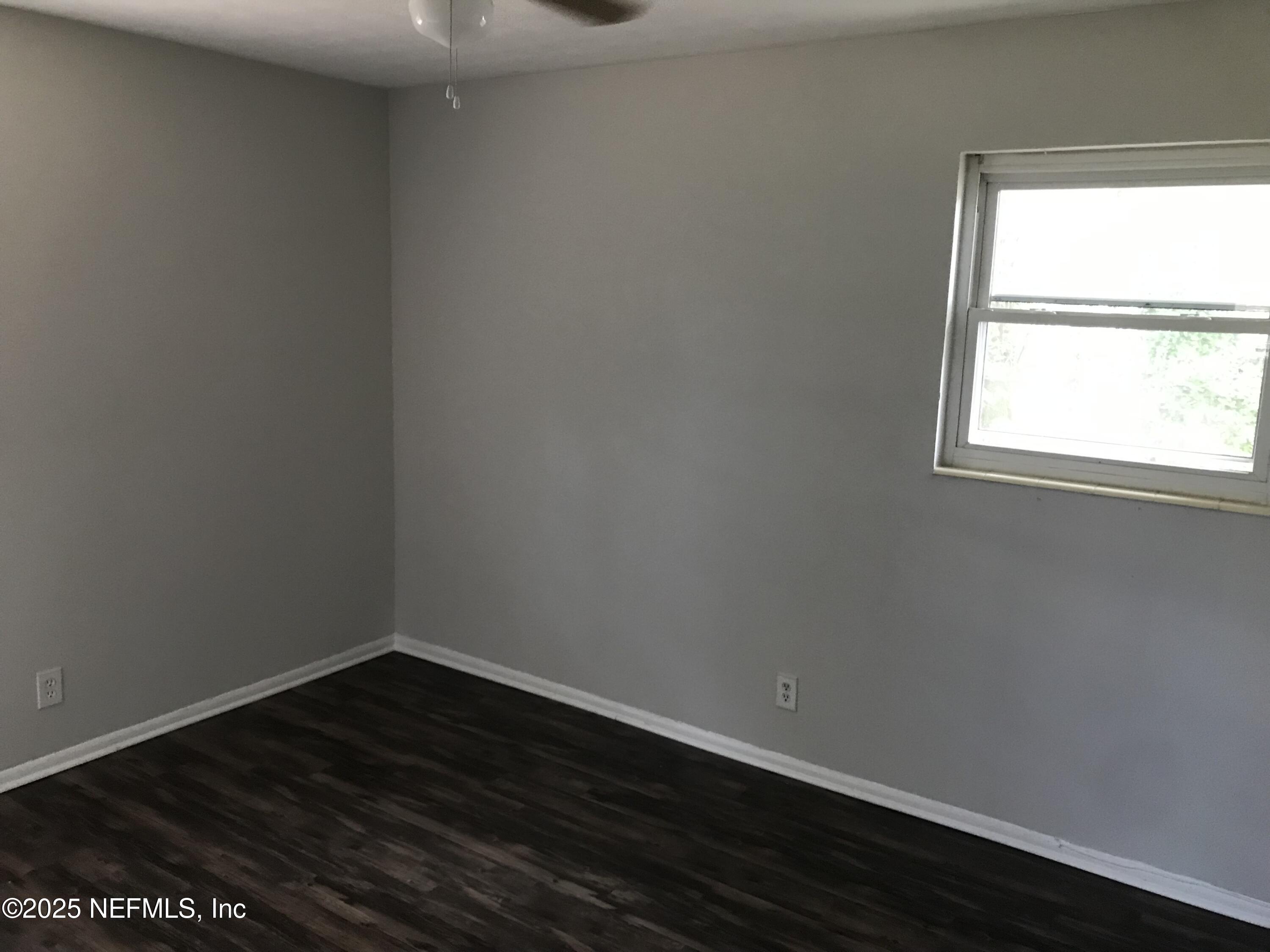 7419 Sandhurst Road South Jacksonville, FL 32277 - Photo 10 of 16 a view of a small space with wooden floor and a window