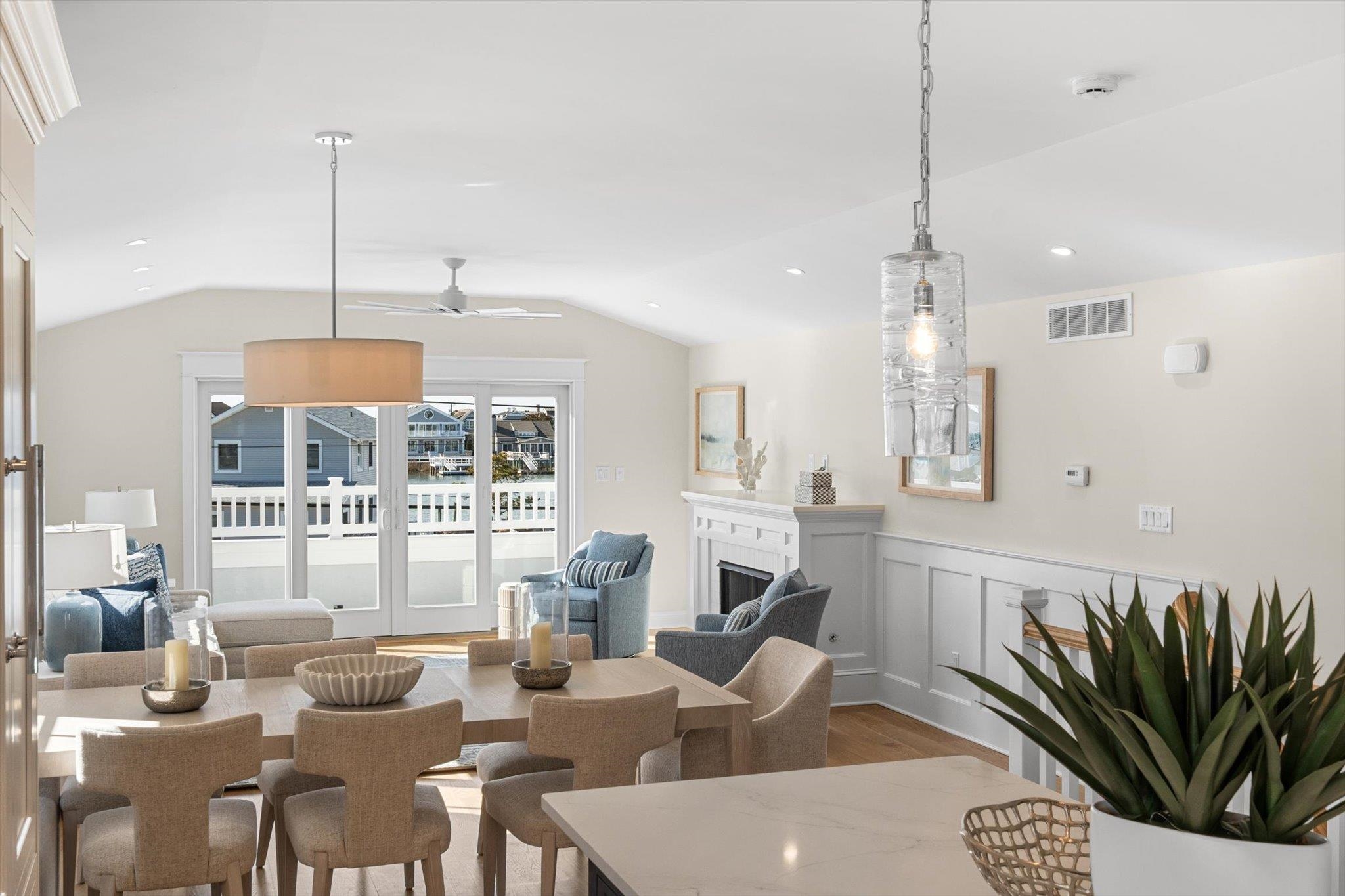 10700 3rd, Unit SOUTH Stone Harbor, NJ 08247 - Photo 11 of 30 a living room with furniture a chandelier and a floor to ceiling window