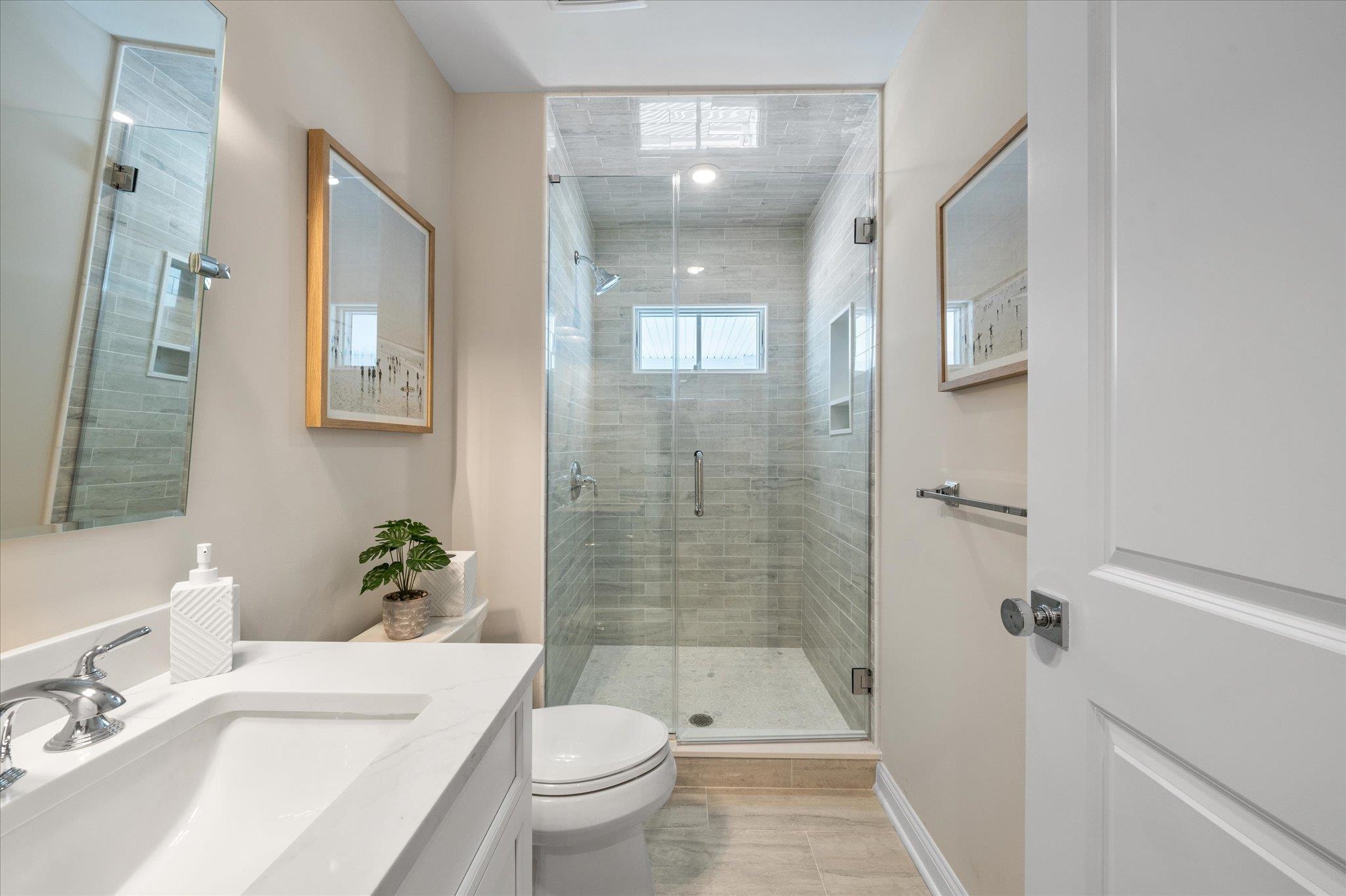 10700 3rd, Unit SOUTH Stone Harbor, NJ 08247 - Photo 16 of 30 a bathroom with a sink toilet and shower