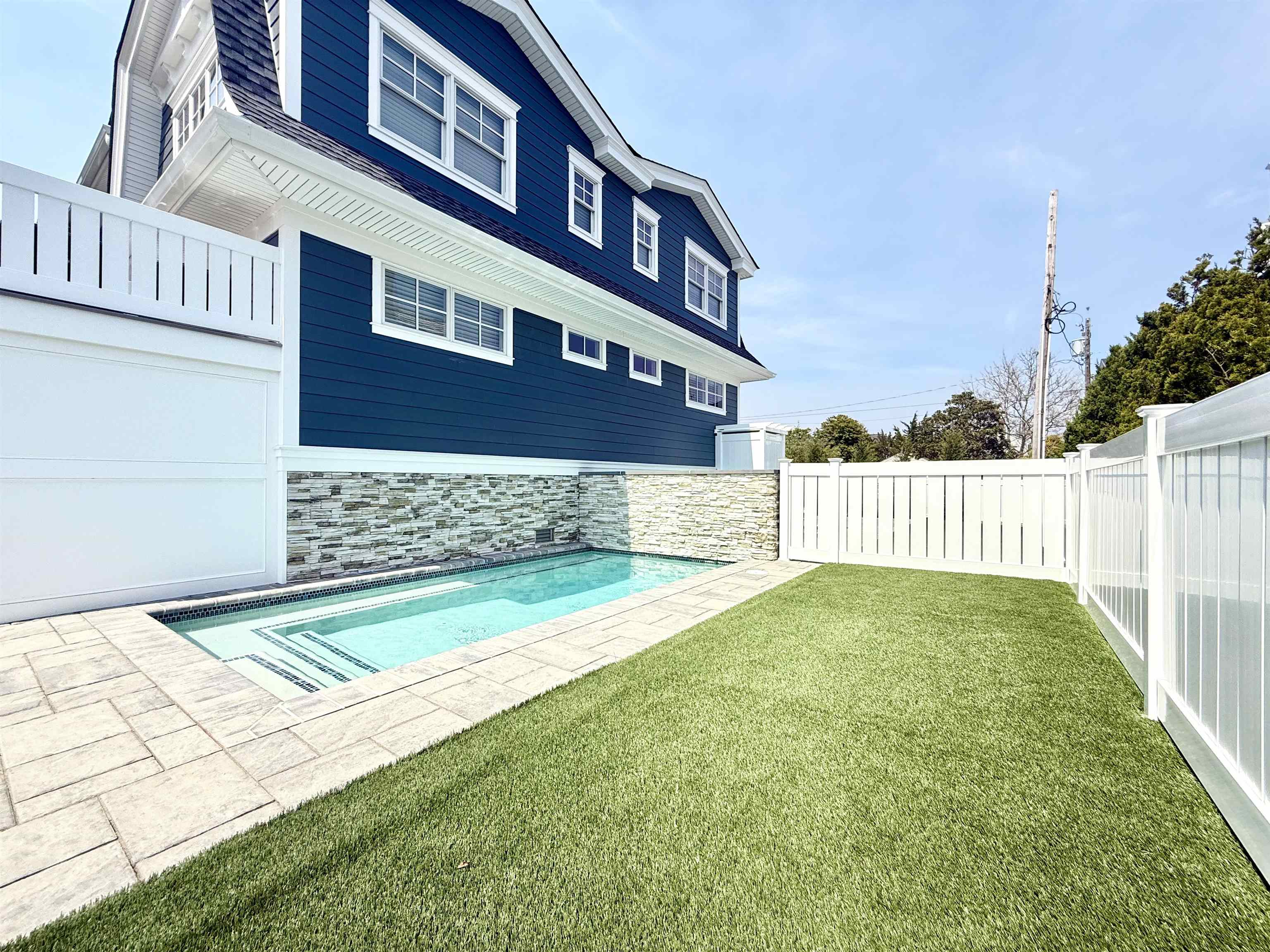 10700 3rd, Unit SOUTH Stone Harbor, NJ 08247 - Photo 2 of 30 a view of a house with a yard and a wooden fence