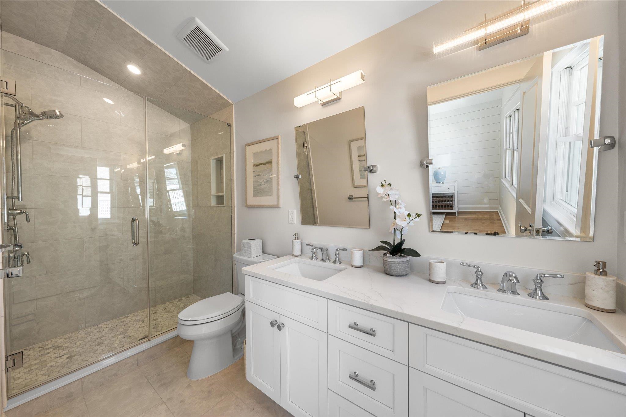 10700 3rd, Unit SOUTH Stone Harbor, NJ 08247 - Photo 21 of 30 a bathroom with double sink and a mirror